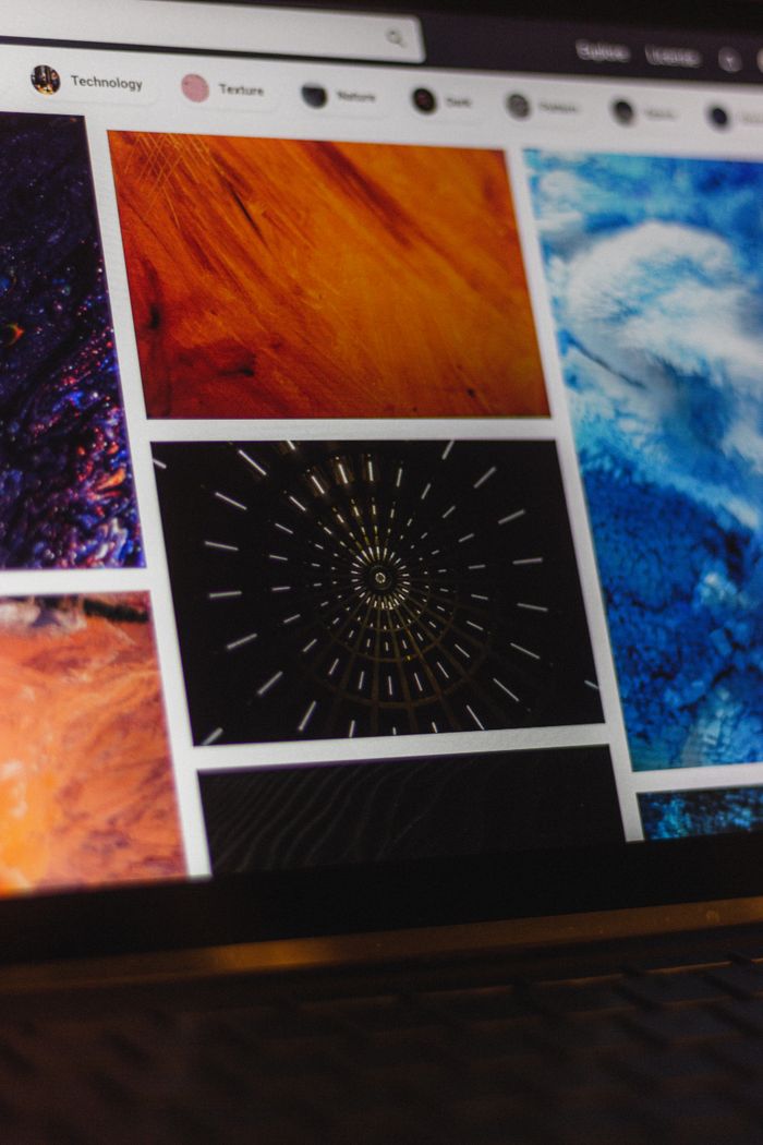 creative-03 Portable computer with website representing assorted abstract photos under favorites and browser search engine with magnifier symbol